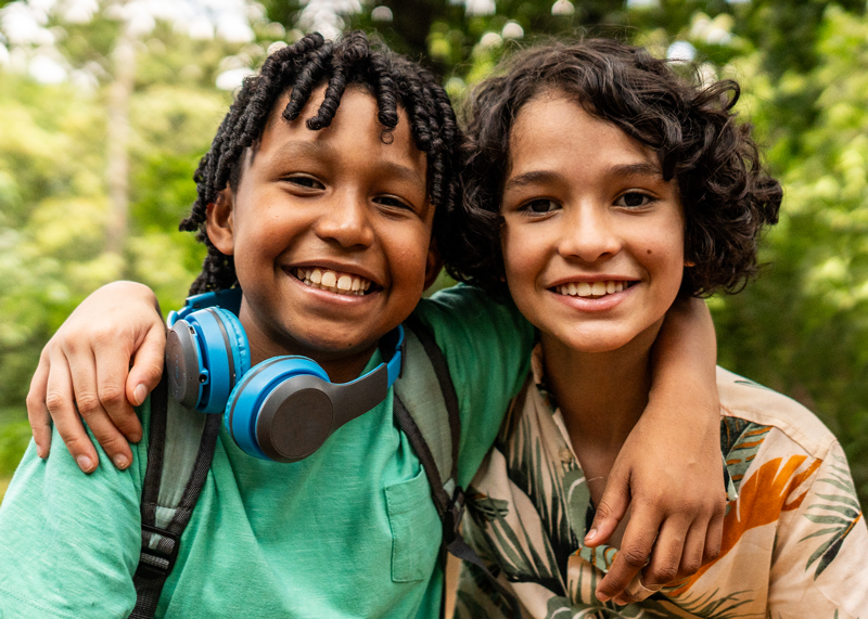 two students smiling outdoors