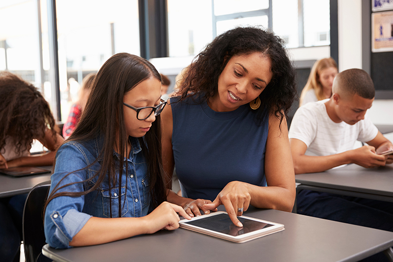 Teacher helping a student.
